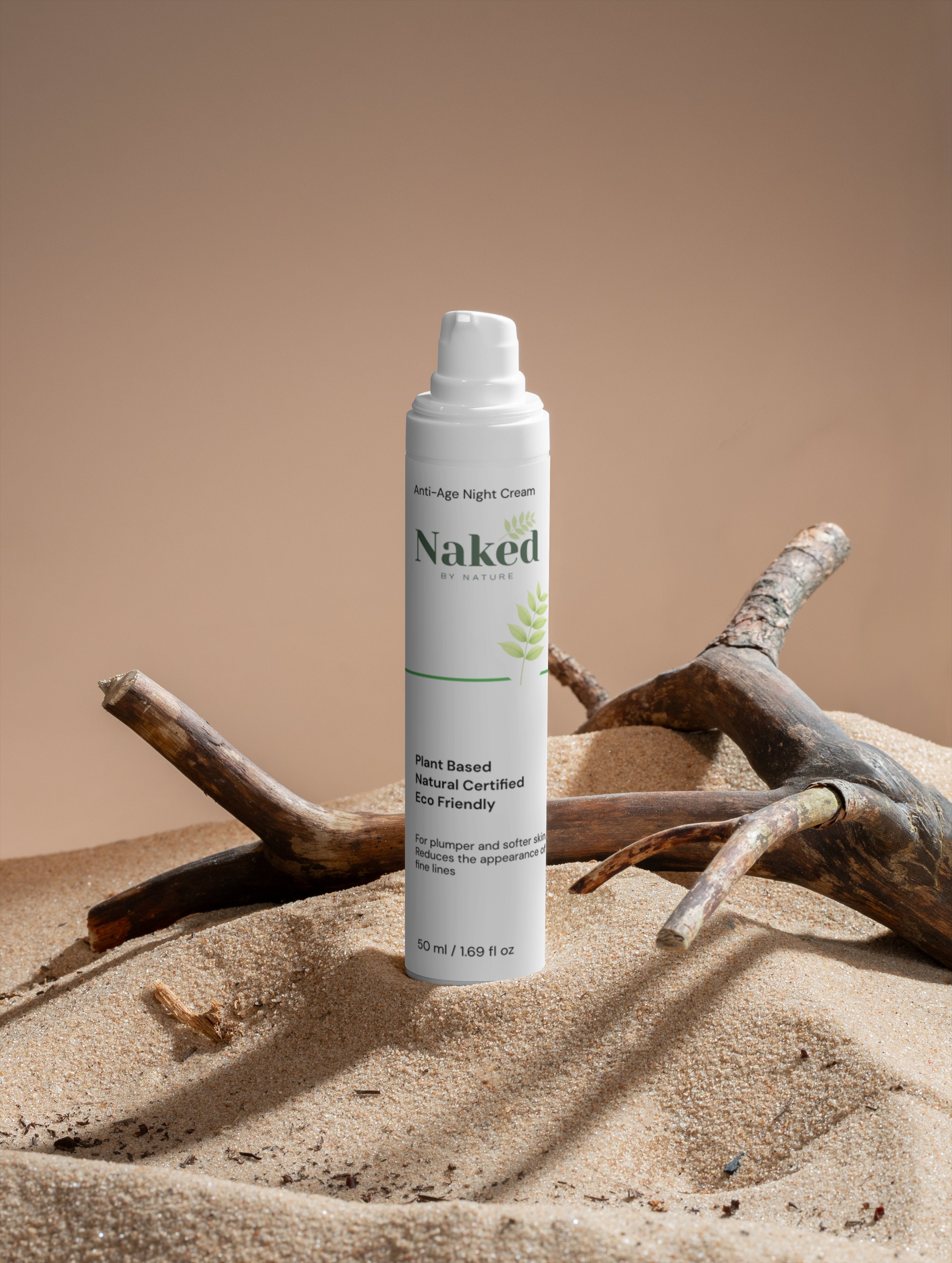 Plant-based anti-age night cream in sand with driftwood, eco-friendly natural skincare