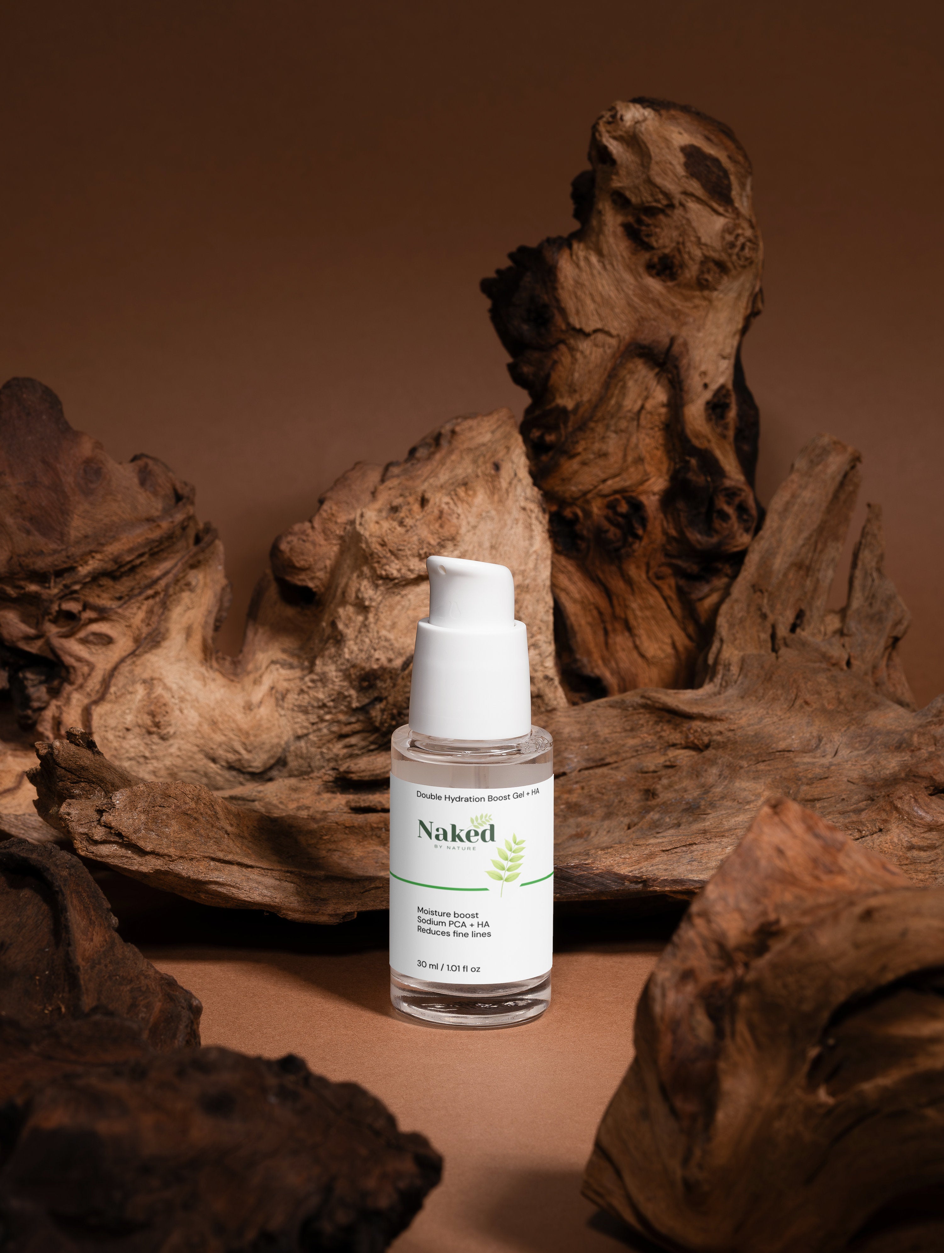 Naked by Nature Double Hydration Boost Gel + HA for moisture boost and fine line reduction, shown with natural driftwood.