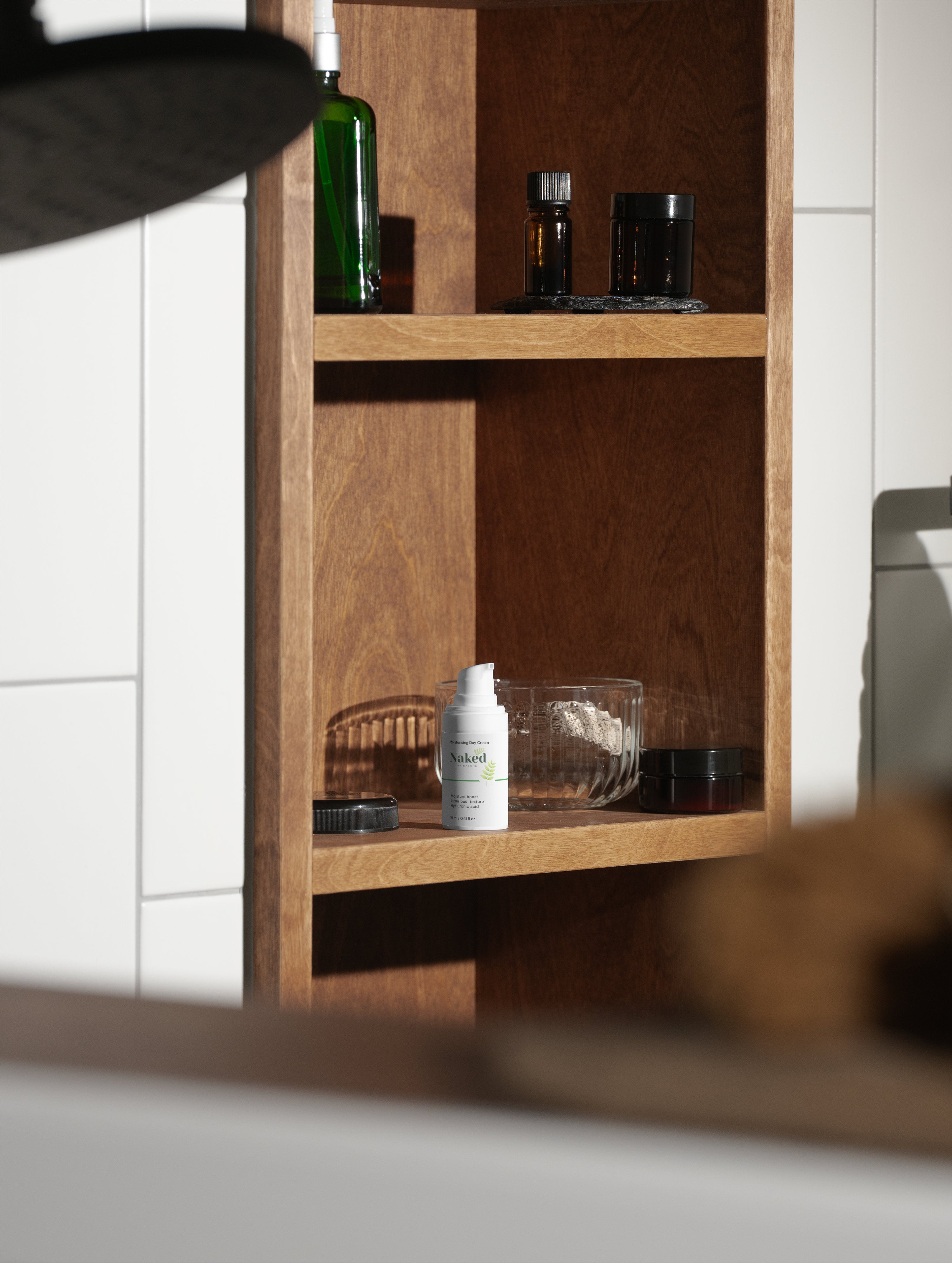 Naked by Nature Moisturising Day Cream on wooden bathroom shelf with natural skincare products