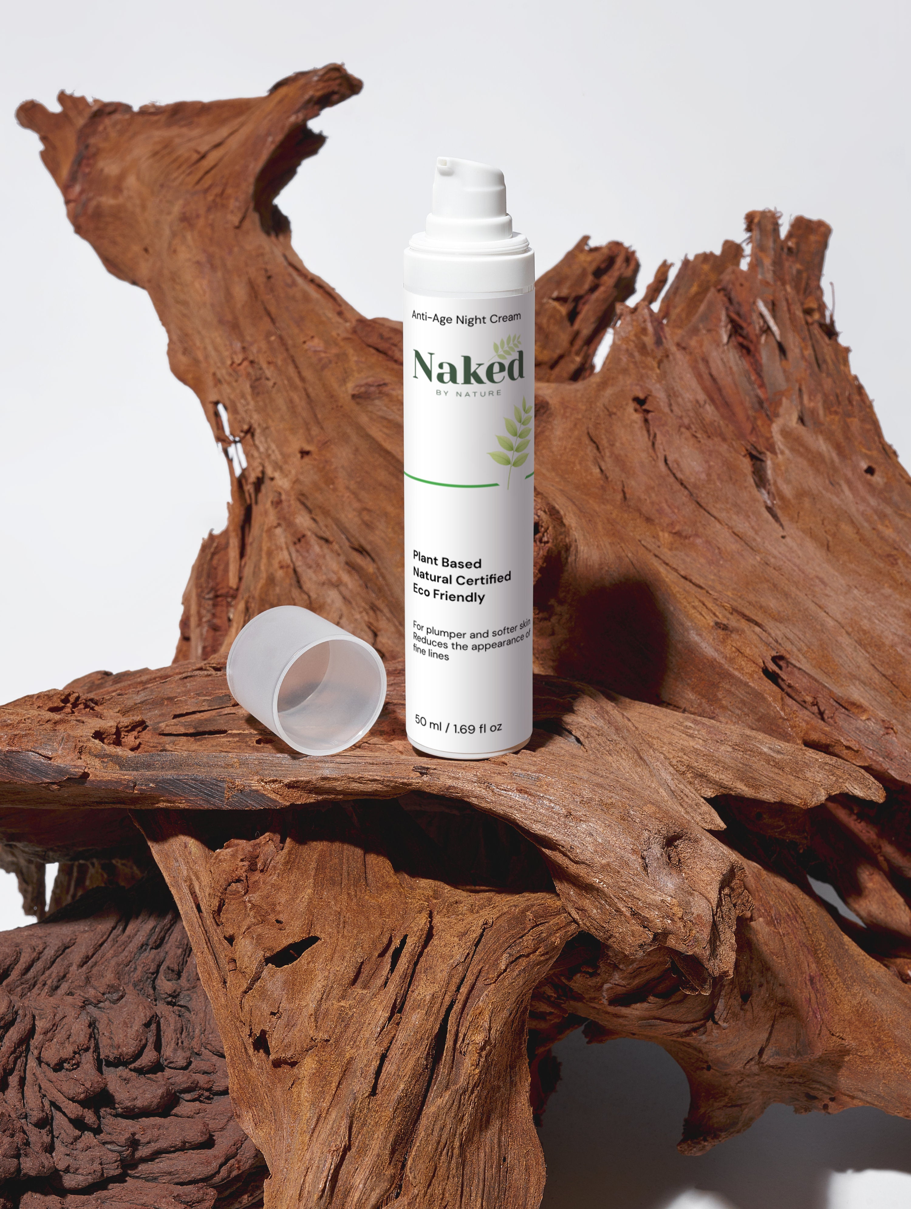 Plant-based anti-age night cream in white bottle on rustic driftwood, eco-friendly skincare for softer skin