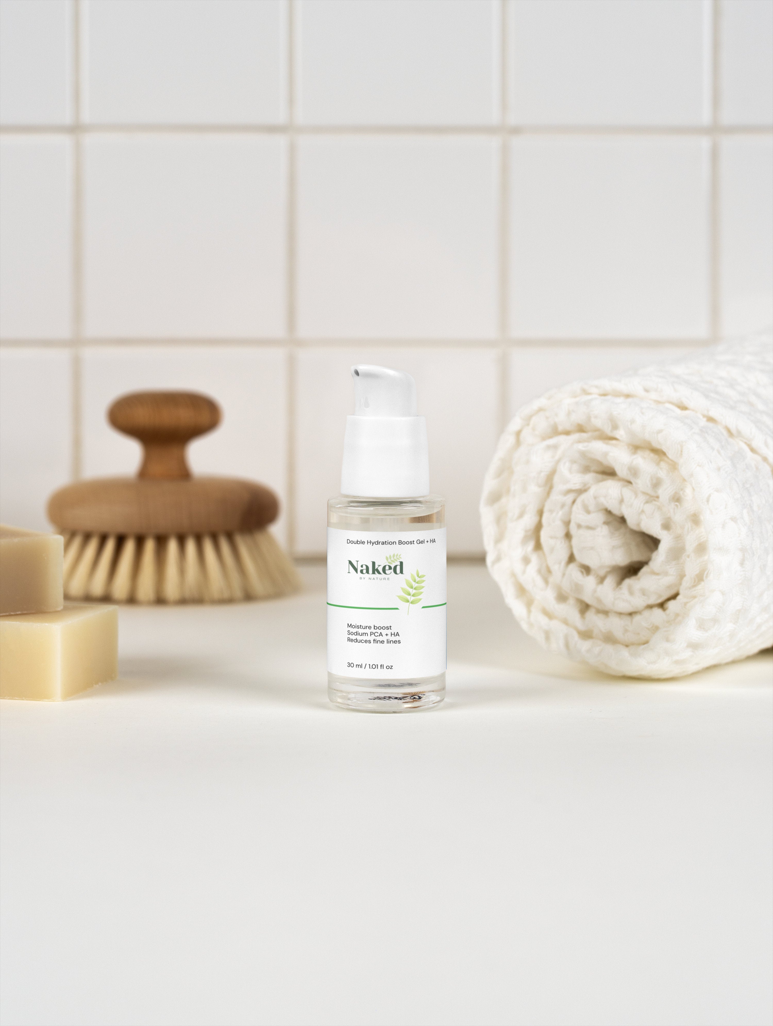 Naked by Nature Double Hydration Boost Gel + HA with Sodium PCA, moisturizer for fine lines, beside towel and soap