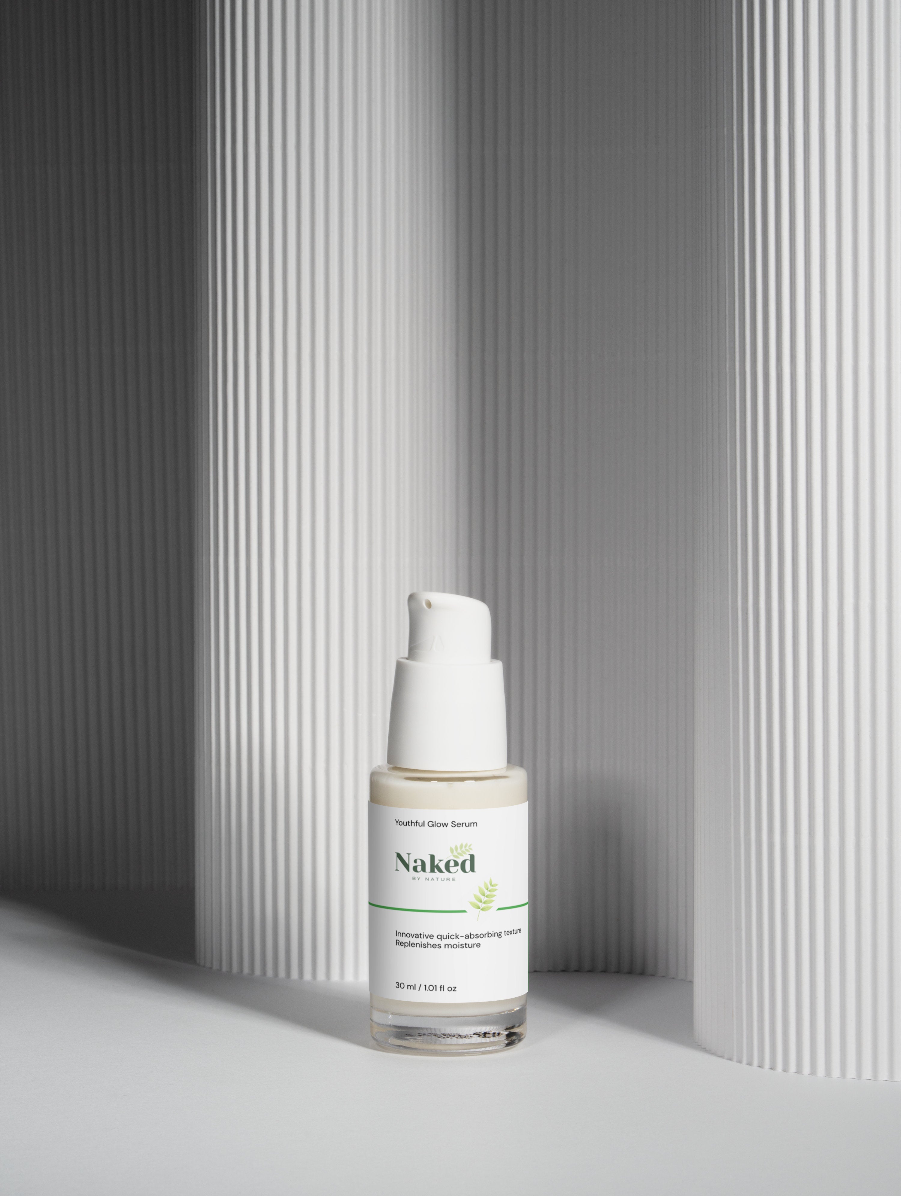 Youthful Glow Serum in clear bottle with white pump, set against modern striped backdrop, replenishes moisture