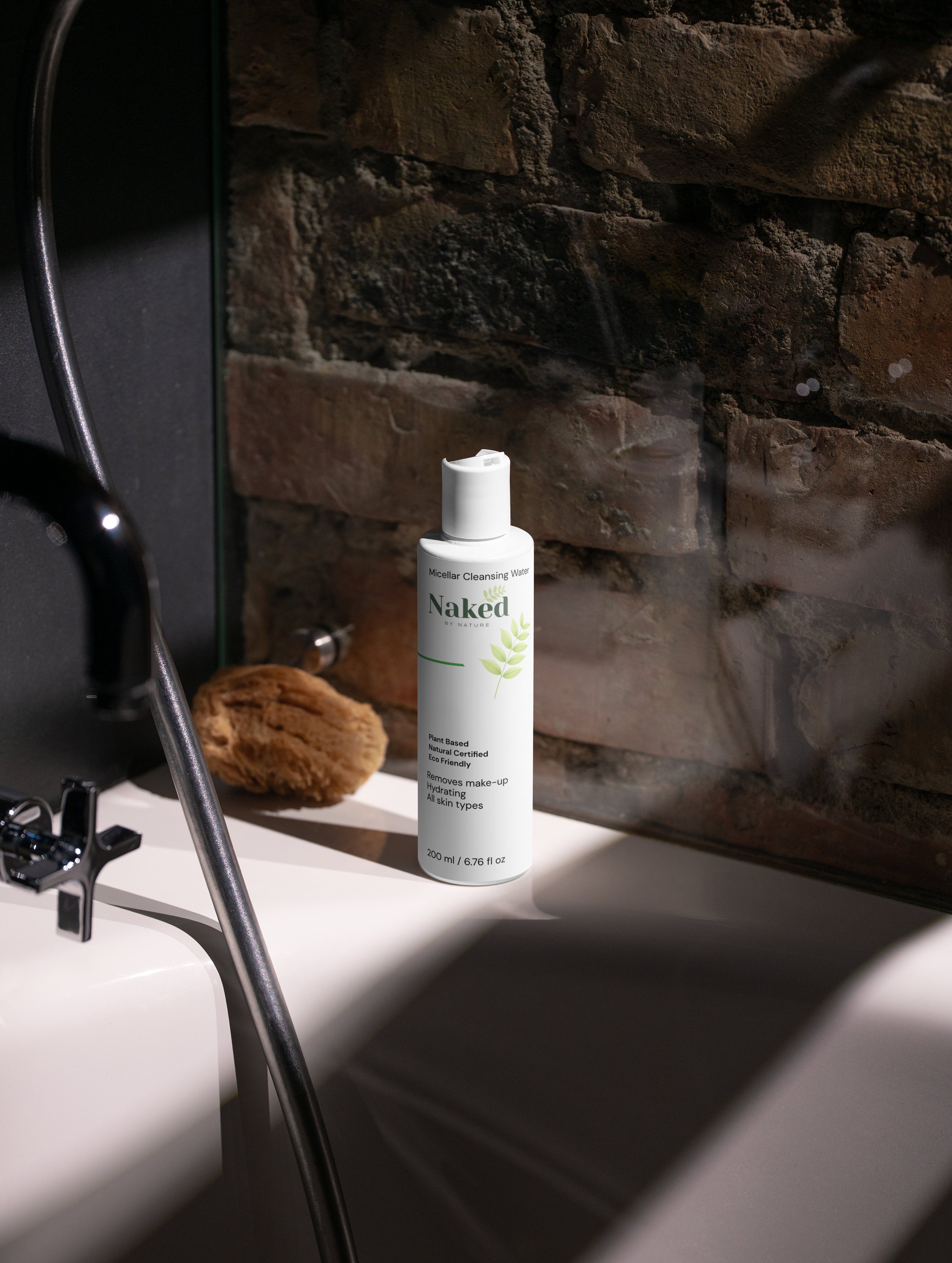 Naked by Nature Micellar Cleansing Water bottle on bathroom sink, plant-based, hydrating, removes makeup for all skin types