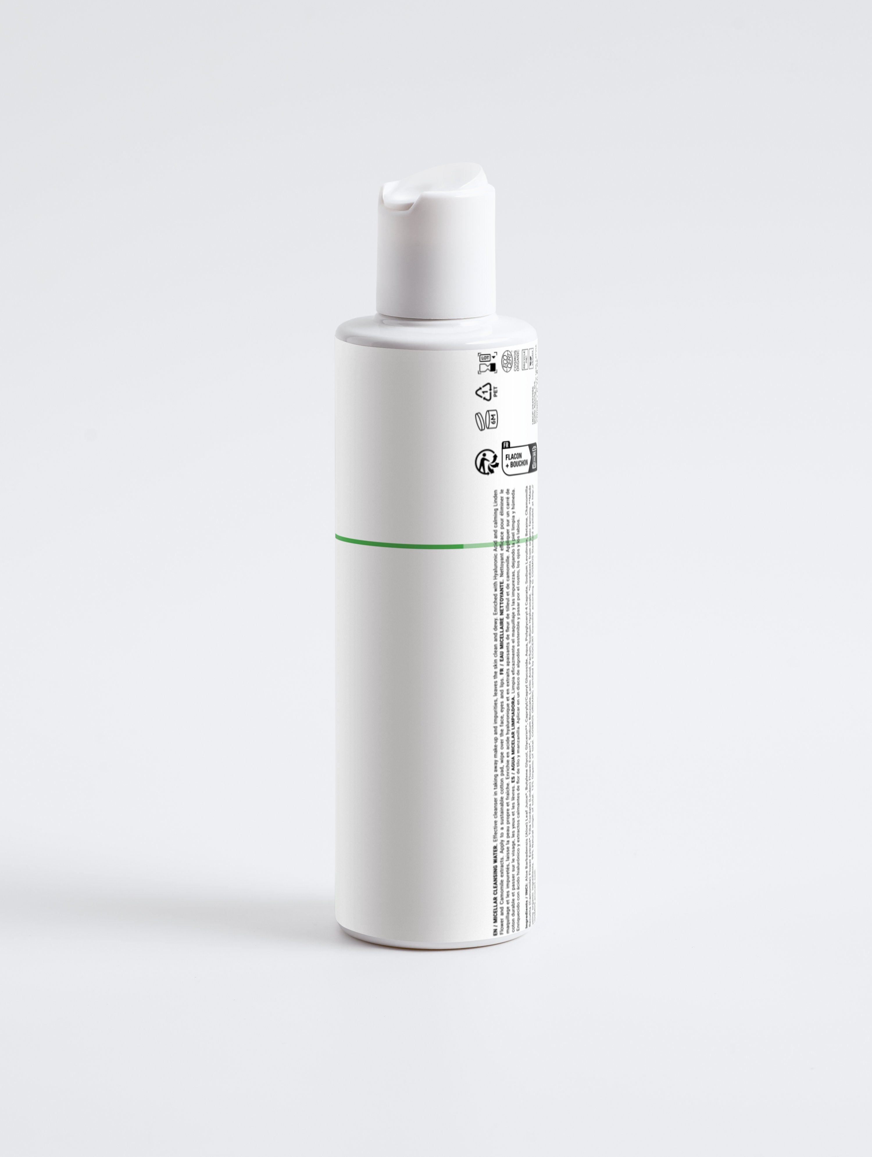 White bottle of micellar cleansing water with green accent, plant-based skincare for face and eyes