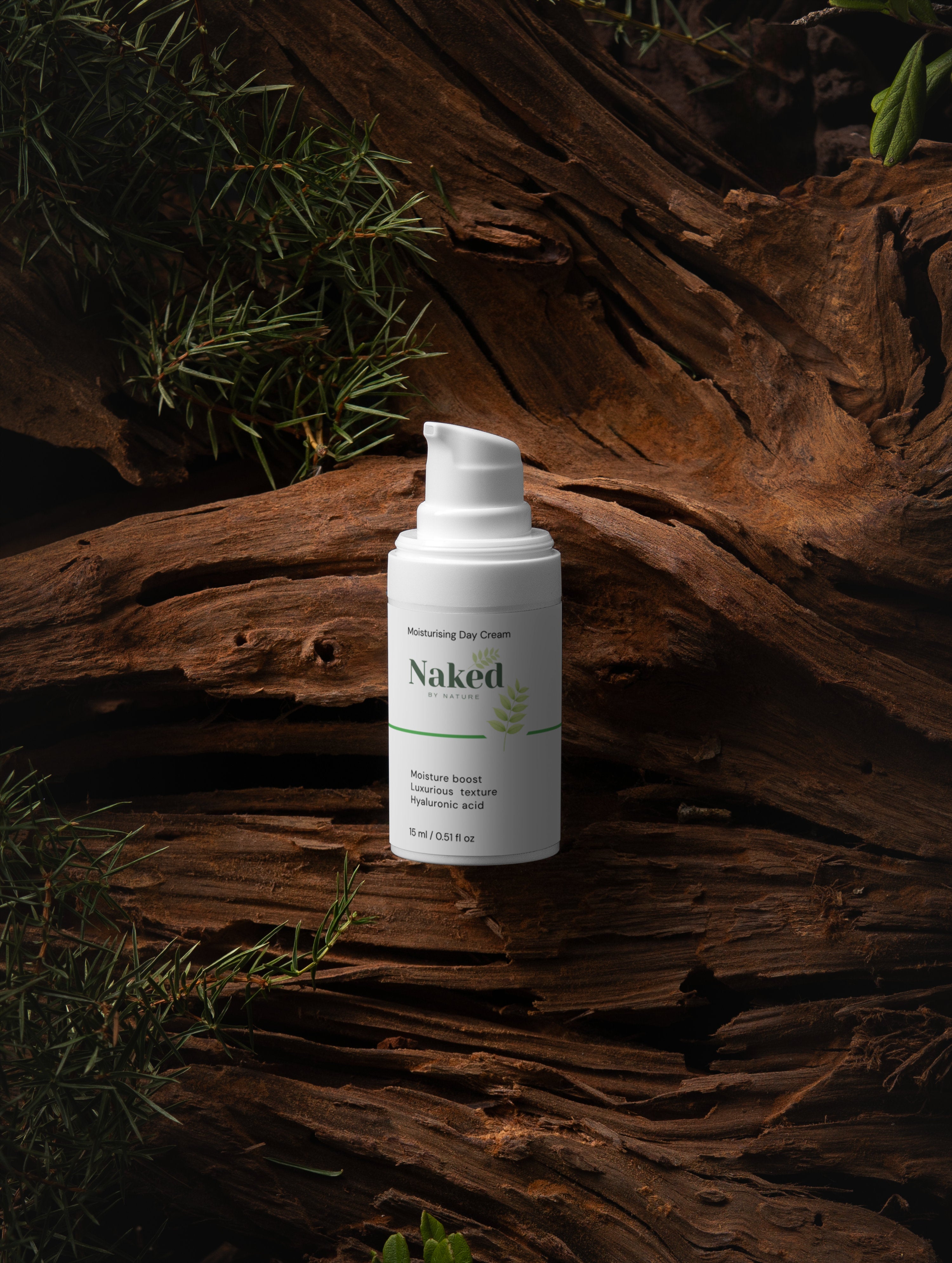 Naked by Nature Moisturising Day Cream with hyaluronic acid, nestled on rustic wood with greenery, for natural skincare.