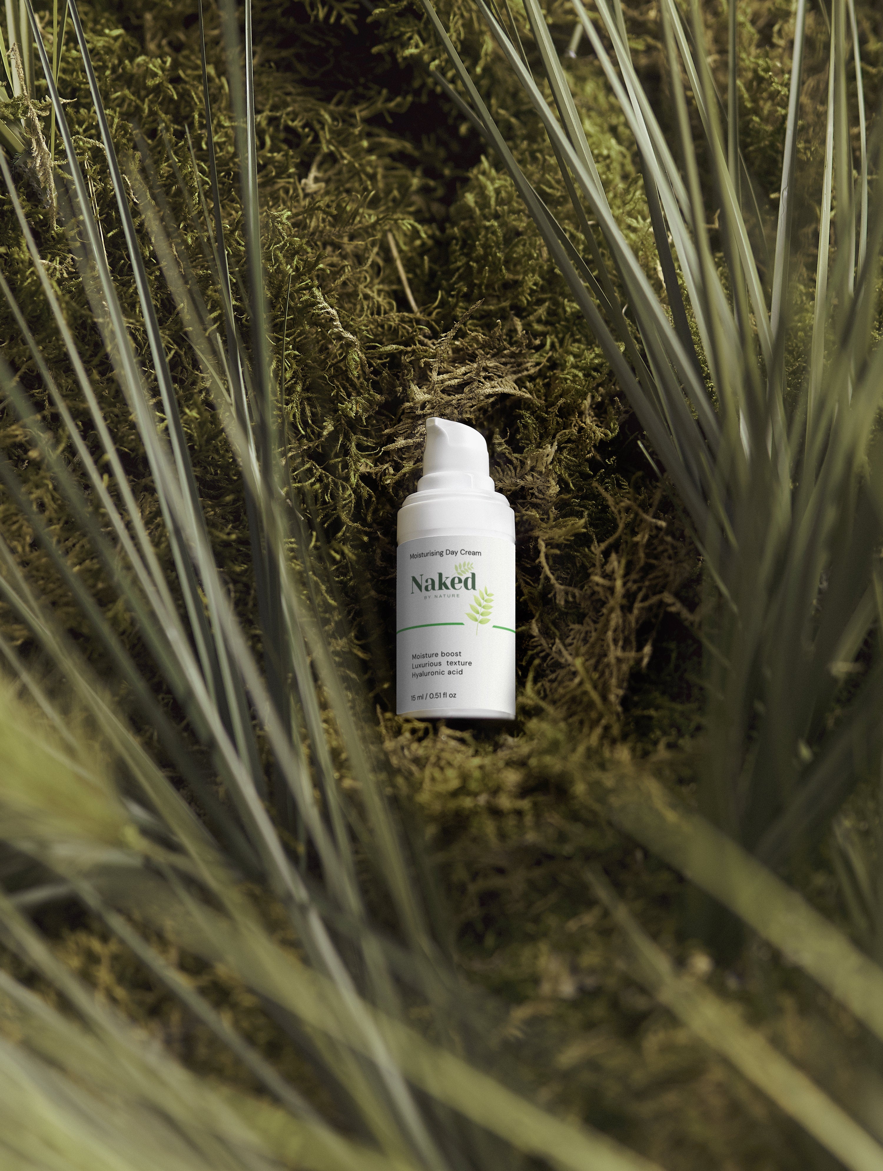 Naked by Nature Moisturising Day Cream with hyaluronic acid, nestled in moss and grass for natural skincare